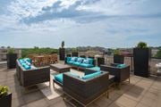 Washington apartment for rent - A patio with wicker furniture and blue cushions.