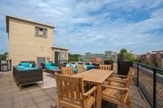 Washington apartment for rent - A patio with a table and chairs overlooks a cityscape.