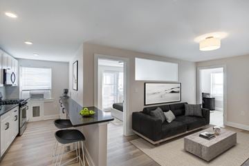 Washington apartment for rent - a living room and kitchen with a couch and a table
