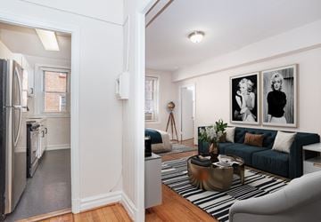 Washington apartment for rent - A living room with a blue couch and a fridge in the corner.