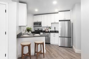 Hyattsville apartment for rent - A kitchen with white cabinets and a grey floor.