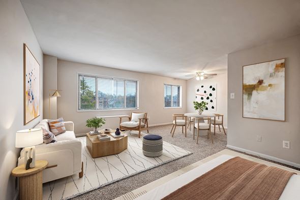 Hyattsville apartment for rent - A living room with a white couch, a wooden coffee table, and a large painting on the wall.
