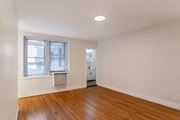 Washington apartment for rent - A room with a wooden floor and a window with blinds.
