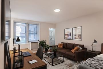 Washington apartment for rent - A modern living room with a brown couch and a black coffee table.