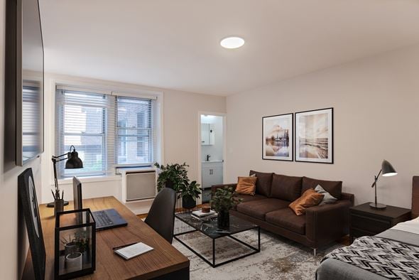 Washington apartment for rent - A modern living room with a brown couch and a black coffee table.