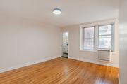 Washington apartment for rent - A room with a wooden floor and a window with blinds.