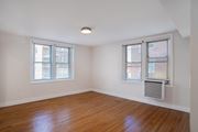 Washington apartment for rent - A room with wooden floors and two windows.