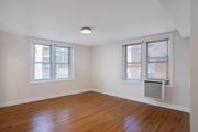Washington apartment for rent - A room with wooden floors and two windows.