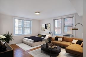 Washington apartment for rent - A bedroom with a bed, a couch, and a coffee table.