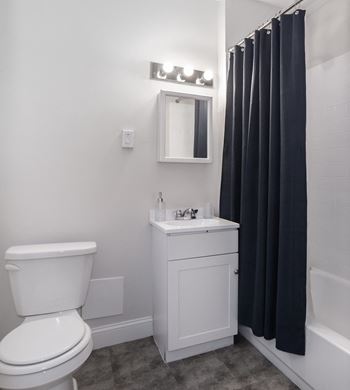Bathrooms with ceramic tile, operable windows, and vanity storage cabinet