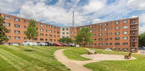 Hyattsville apartment for rent - a large brick building with a park in front of it