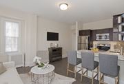Washington apartment for rent - a living room with a kitchen and a table with chairs