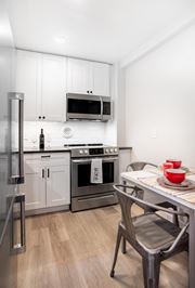 Washington apartment for rent - a kitchen with stainless steel appliances and a table and chairs