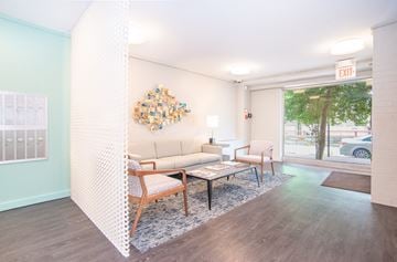Washington apartment for rent - A living room with a white couch and a wooden coffee table.