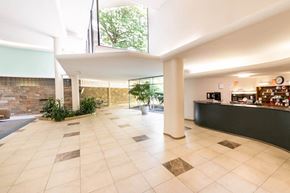 Washington apartment for rent - A spacious lobby with a reception desk and a brick wall.