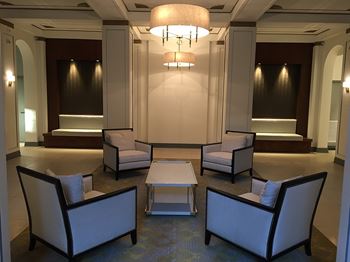 Elegant lobby with original gold-leaf plaster finials and walnut wall paneling