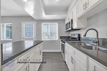 Hawthorne apartment for rent - a kitchen with white cabinets and a sink