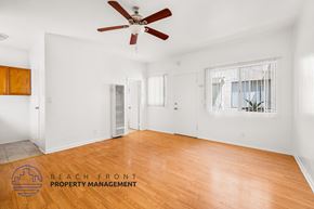 Long Beach apartment for rent - a living room with wood floors and a ceiling fan