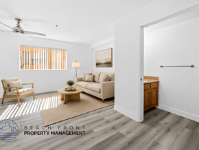 Van Nuys apartment for rent - A spacious room with wooden flooring and a ceiling fan.