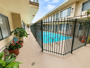 Hawthorne apartment for rent - A black fence surrounds a small pool.