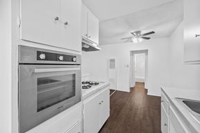 Huntington Park apartment for rent - A modern kitchen with white cabinets and stainless steel appliances.