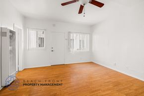 Long Beach apartment for rent - a living room with wood floors and white walls and a ceiling fan