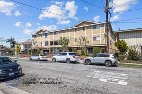 Hawthorne apartment for rent - A car is parked in a parking lot with the words "BEACH FRONT PROPERTY MANAGEMENT" painted on the ground.