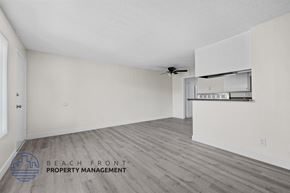 Long Beach apartment for rent - A spacious room with a ceiling fan and a wall-mounted shelf.
