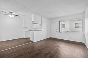 Huntington Park apartment for rent - A room with a ceiling fan and a window with blinds.