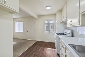 Wilmington apartment for rent - A kitchen with white cabinets and a wooden floor.
