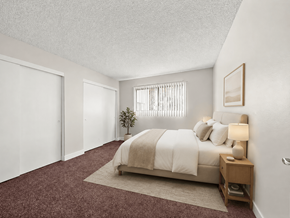 Anaheim apartment for rent - A bedroom with a bed, nightstand, and window.