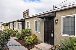 Downey apartment for rent - A row of houses with a sign that says Beach Property Management.
