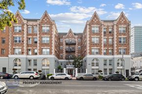 Los Angeles apartment for rent - A large brick building with a parking lot in front of it.