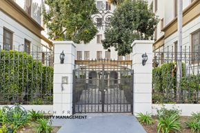 Los Angeles apartment for rent - A gated entrance to a property with a sign that says Beachfront Property Management.