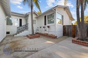 Lomita apartment for rent - A house with a white exterior and a balcony with a black railing.