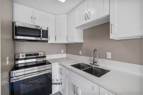 Whittier apartment for rent - A kitchen with white cabinets and a stainless steel oven.
