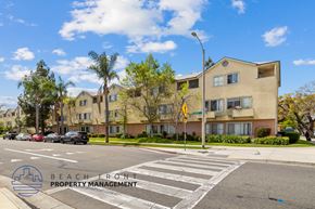 Santa Ana townhouse for rent - A street view of a residential area with a crosswalk and apartment buildings.