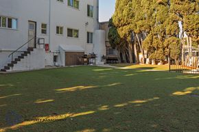 Long Beach apartment for rent - A white building with a green lawn in front of it.