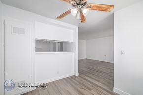 Hawthorne apartment for rent - A room with a ceiling fan and wooden flooring.