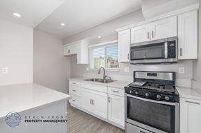 Hawthorne apartment for rent - A kitchen with a stove, sink, and microwave.
