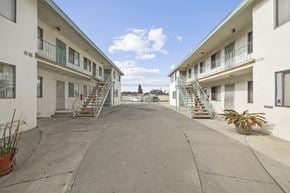 Wilmington apartment for rent - A courtyard between two buildings with staircases leading to the upper floors.
