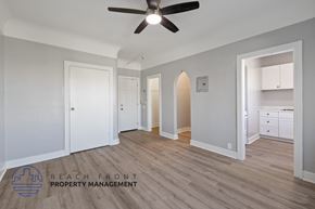 Los Angeles apartment for rent - a renovated living room with a ceiling fan and a hallway to two closets