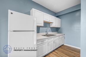 Los Angeles apartment for rent - a kitchen with white cabinets and a refrigerator