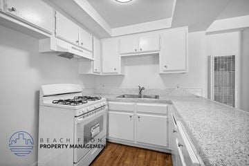 Wilmington apartment for rent - an image of a kitchen with white cabinets and a white stove and white counter tops