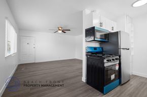 Signal Hill apartment for rent - A kitchen area with a stove, oven, microwave, and a fan.