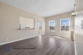 Los Angeles apartment for rent - A spacious room with wooden flooring and a view of K-town through the windows.