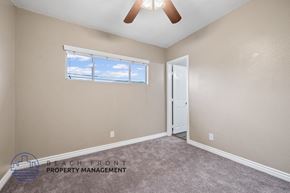 Downey apartment for rent - the living room of a house with a ceiling fan and a window