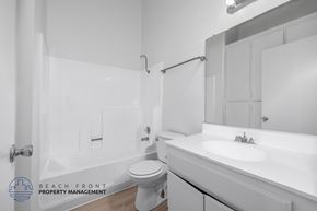 Hawthorne apartment for rent - A white bathroom with a toilet, sink, and bathtub.