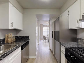 Paramount apartment for rent - A kitchen with white cabinets and a black stove top oven.