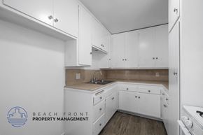 Inglewood apartment for rent - a kitchen with white cabinets and white appliances and a sink